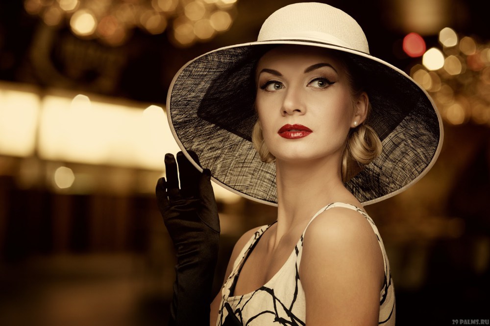 Woman in hat over blurred background.