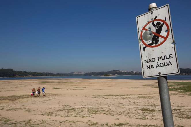 More than 10 million people across Sao Paulo have been forced to cut water over the past six months as southeastern Brazil suffers its worst drought in more than eight decades.
In picture: A Portuguese sign on the receding banks of the Guarapiranga dam reads: "Don't dive in to the water."