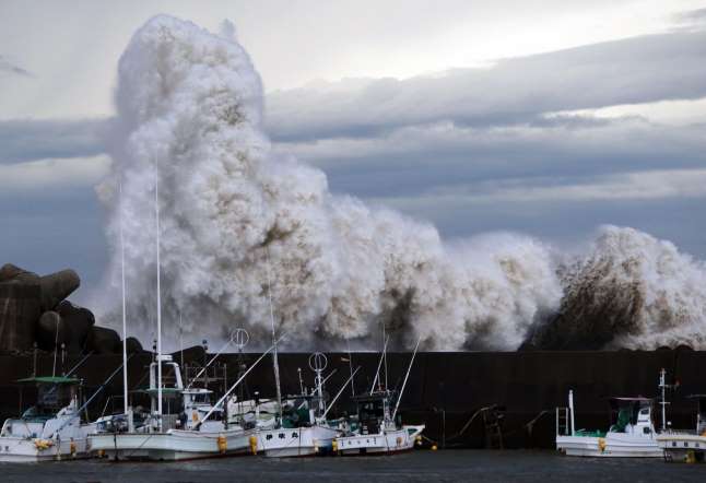 High waves batter a breakwater at a port at Kihou town in Mie prefecture, central Japan on October 6, 2014.
