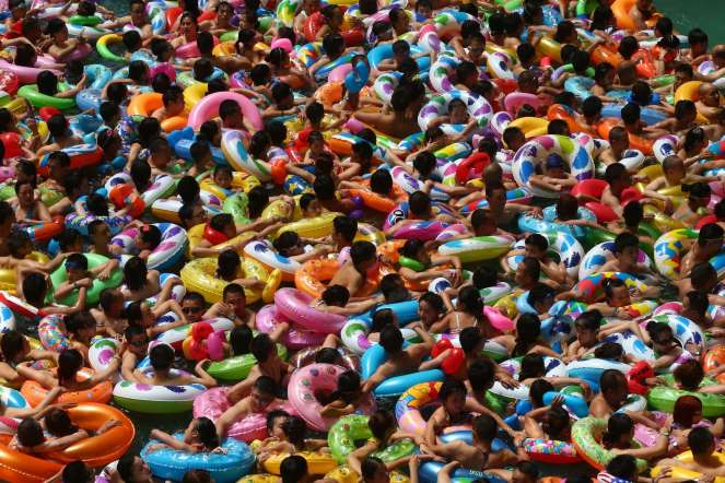 People cooling off in a waterpark in Suining, southwest China's Sichuan province on July 25, 2014.