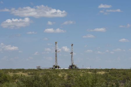 Horizontal drilling rigs operate in the Permian Basin oil production area near Wink, Texas U.S. August 22, 2018. Picture taken August 22, 2018. REUTERS/Nick Oxford