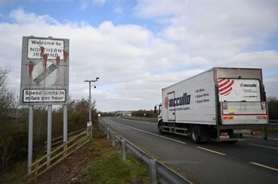 A truck drives past a defaced 'Welcome to Northern Ireland' sign on the Ireland and Northern Ireland border in Carrickcarnan, Ireland, March 6, 2021. REUTERS/Clodagh Kilcoyne A truck drives past a defaced 'Welcome to Northern Ireland' sign on the Ireland and Northern Ireland border in Carrickcarnan, Ireland, March 6, 2021. REUTERS/Clodagh Kilcoyne