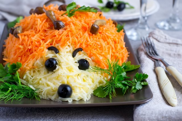colorful salad is decorated in the form of a hedgehog. idea for children's menu. Selective focus