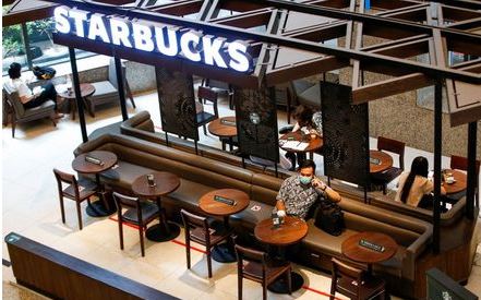 A man wearing a protective mask uses a phone at Starbucks cafe inside the Indonesia Stock Exchange (IDX) building, as the coronavirus disease (COVID-19) outbreak continues, in Jakarta, Indonesia, September 8, 2020. REUTERS/Willy Kurniawan A man wearing a protective mask uses a phone at Starbucks cafe inside the Indonesia Stock Exchange (IDX) building, as the coronavirus disease (COVID-19) outbreak continues, in Jakarta, Indonesia, September 8, 2020. REUTERS/Willy Kurniawan