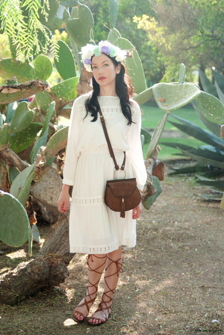 Модель в летнем белом платье, коричневая сумочка и сандалии гладиаторы