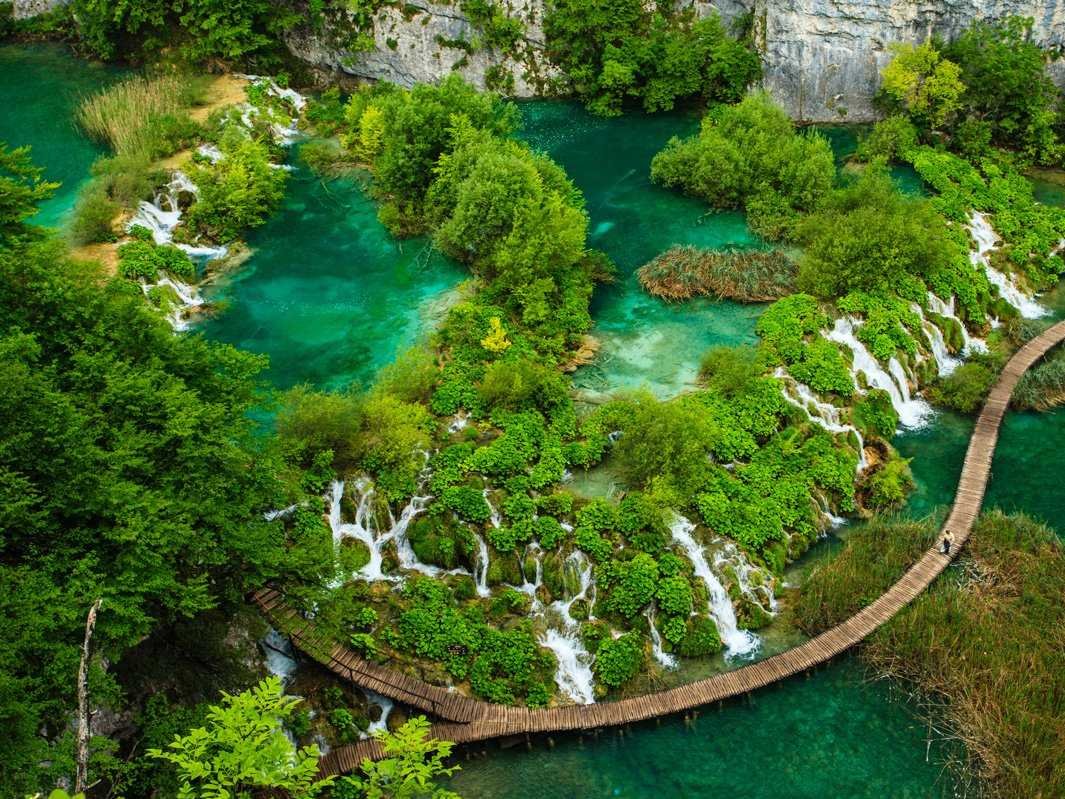 an-aerial-photo-captures-the-beauty-of-croatias-plitvice-lakes-national-park-the-park-is-made-up-of-cascading-lakes-that-range-in-color-from-green-to-blue-to-gray-the-lakes-were-created-when-shallow-basins-forme