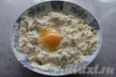 К получившейся крошке добавить яйцо.