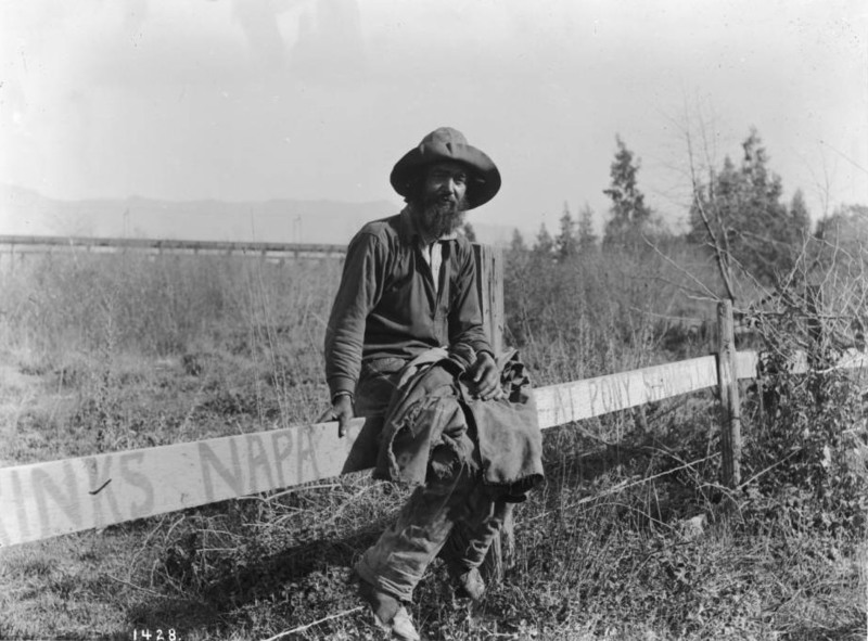 Hobo sitting on a fence, c.1920