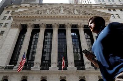 A person walks by the New York Stock Exchange (NYSE) in New York City, New York, U.S., July 19, 2021. REUTERS/Andrew Kelly A person walks by the New York Stock Exchange (NYSE) in New York City, New York, U.S., July 19, 2021. REUTERS/Andrew Kelly