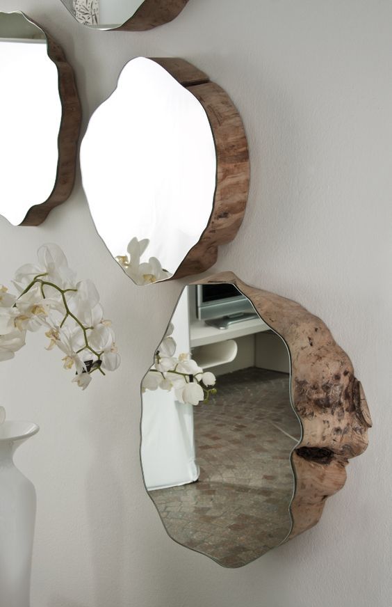 Mirror mounted to natural wood cuts.