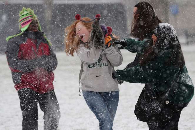 Student tourists from Chattanooga, Tennessee, have a snowball fight on  National Mall on January 21, 2014.