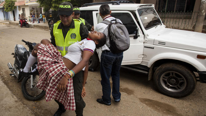 A teenage girl is brought to hospital in Carmen de Bolivar, Bolivar Province, Colombia, after fainting on September 2, 2014