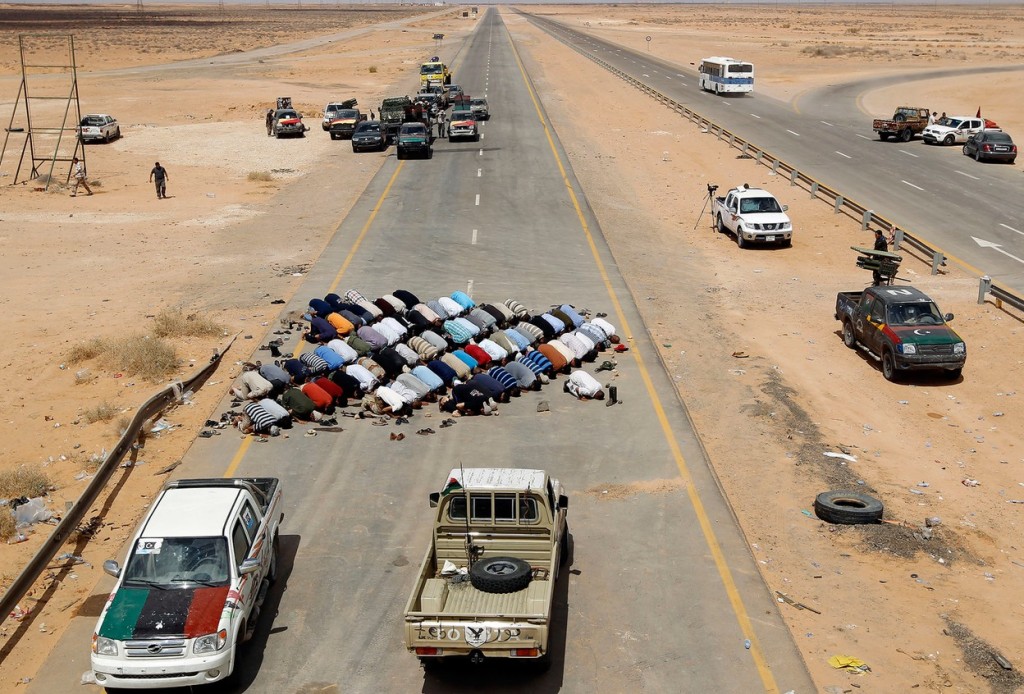 Ливийские повстанцы на контрольно-пропускном пункте около города Абу-Грейн, расположенного в 160 километрах от Сирта — одного из последних оплотов Муаммара Каддафи. Фото: Reuters