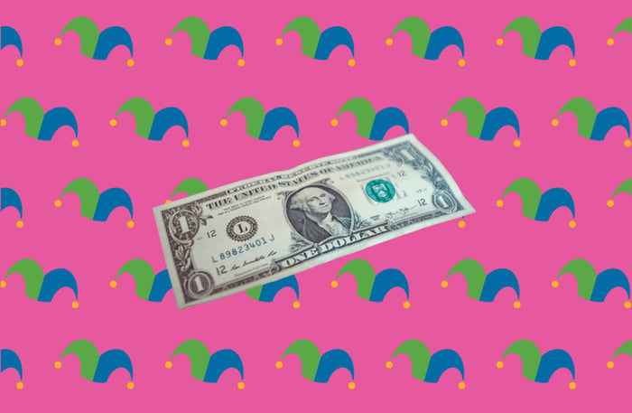 A dollar bill against a pink background