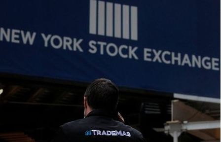 Trader Frank Masiello talks on his phone on Wall St. outside the New York Stock Exchange (NYSE) in New York, U.S., January 15, 2021. REUTERS/Brendan McDermid