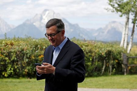 Federal Reserve Vice Chair Richard Clarida reacts as he holds his phone during the three-day "Challenges for Monetary Policy" conference in Jackson Hole, Wyoming, U.S., August 23, 2019. 
<div id=