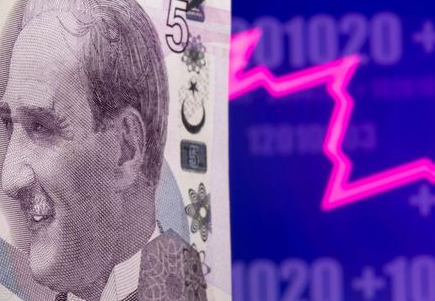 A Turkish lira banknote is seen in front of displayed stock graph in this illustration taken May 7, 2021. REUTERS/Dado Ruvic/Illustration