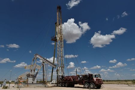 A work over rig performs maintenance on an oil well in the Permian Basin oil production area near Wink, Texas U.S. August 22, 2018. Picture taken August 22, 2018. REUTERS/Nick Oxford 