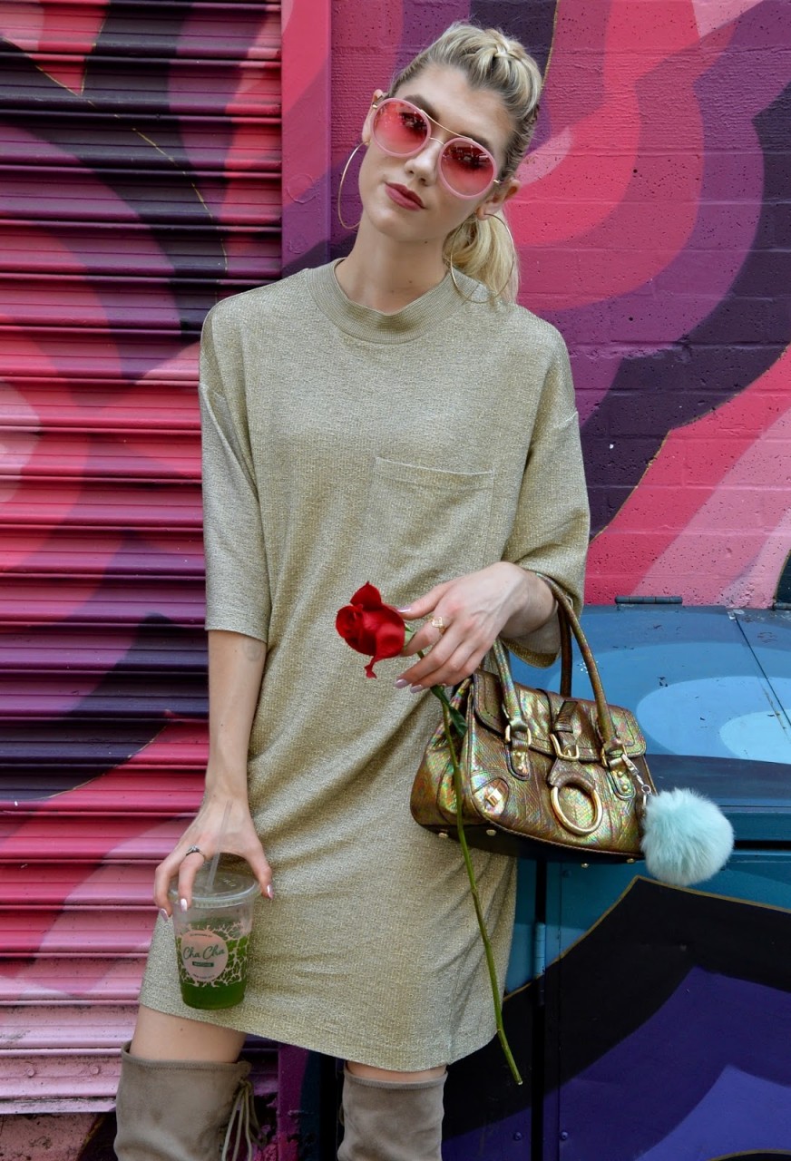 Giving sass in a gold tee shirt dress with a vintage purse and rose.  
