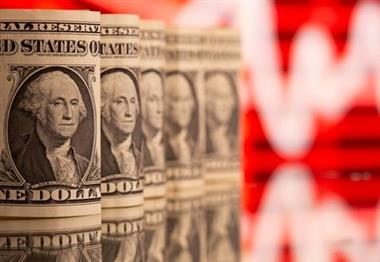 FILE PHOTO: U.S. One dollar banknotes are seen in front of displayed stock graph in this illustration taken, February 8, 2021. REUTERS/Dado Ruvic/Illustration/File Photo 