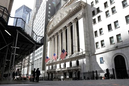 People are seen on Wall St. outside the New York Stock Exchange (NYSE) in New York City, U.S., March 19, 2021. REUTERS/Brendan McDermid