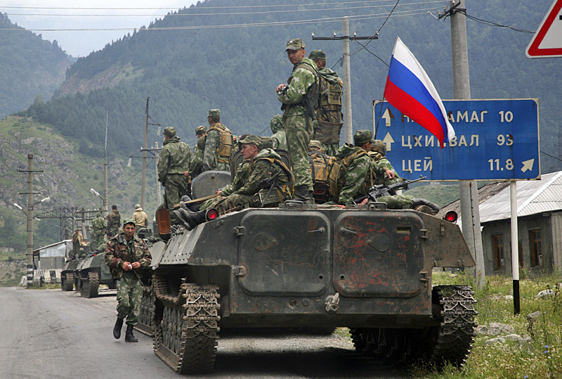 A column of Russian armored vehicles, heading towards the breakaway Georgian province of South Ossetia, are seen in North Ossetia, Russia, Friday, Aug. 8, 2008. A surprise military offensive by Georgia, a staunch U.S. ally, to retake the breakaway province of South Ossetia reportedly killed hundreds of people Friday, triggering a ferocious counterattack from Russia that threatened to plunge the region into full-scale war. (AP Photo/Musa Sadulayev)