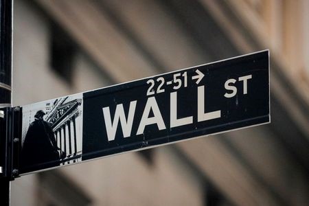 A Wall St. sign is seen near the New York Stock Exchange (NYSE) in the financial district in New York, U.S., November 24, 2020. REUTERS/Brendan McDermid
