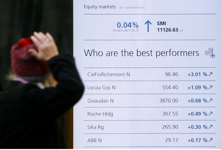 Swiss luxury group Richemont heads a list of the best performing stocks, seen on a display in a window of the Swiss bank UBS headquarters in Zurich, Switzerland April 14, 2021. REUTERS/Arnd Wiegmann