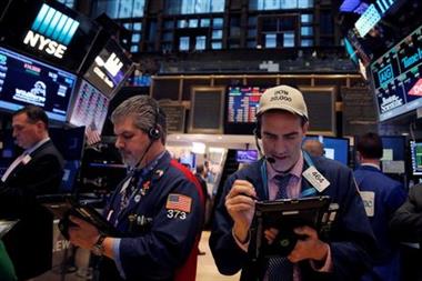 Traders work on the floor at the New York Stock Exchange (NYSE) in Manhattan, New York City, U.S., December 21, 2016. REUTERS/Andrew Kelly 
