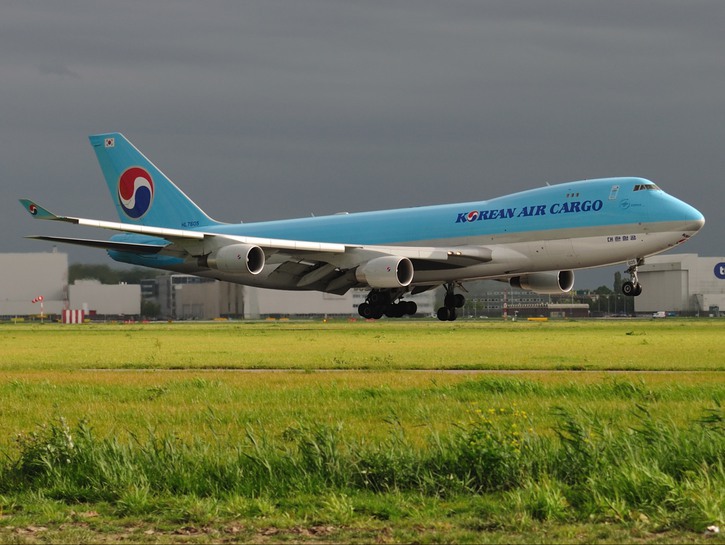 Korean Air cargo plane on runway, dark clouds in background