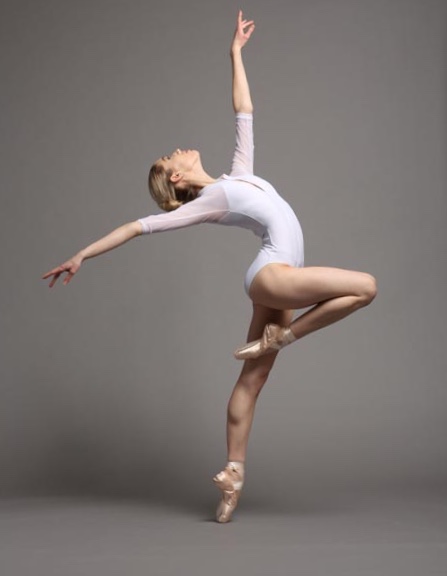 Reaching for the stars in a white eleve leotard