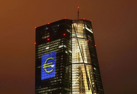 The headquarters of the European Central Bank (ECB) are illuminated with a giant euro sign at the start of the "Luminale, light and building" event in Frankfurt, Germany, March 12, 2016. EUTERS/Kai Pfaffenbach/File Photo