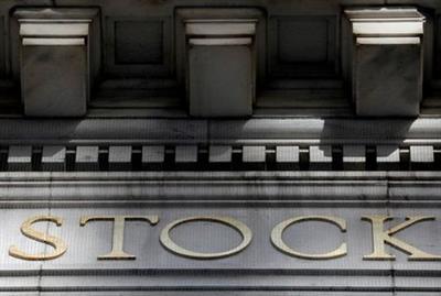 FILE PHOTO: Morning sunlight falls on the facade of the New York Stock Exchange (NYSE) building after the start of Thursday's trading session in Manhattan in New York City, New York, U.S., January 28, 2021. REUTERS/Mike Segar/File Photo