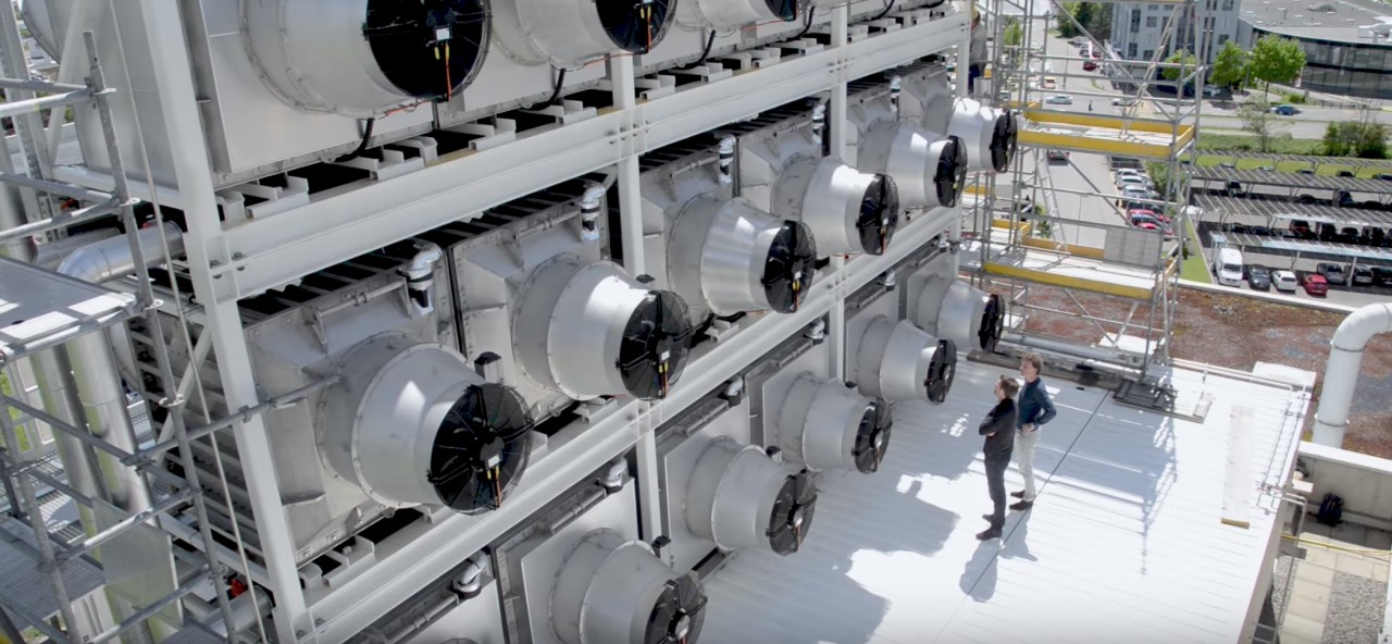 Climeworks founders in front ofna CO2 capture module in Switzerland