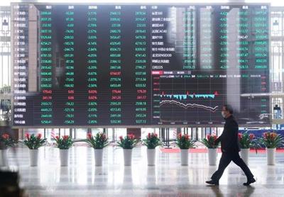 FILE PHOTO: A man wearing a face mask is seen inside the Shanghai Stock Exchange building at the Pudong financial district in Shanghai, China February 28, 2020. REUTERS/Aly Song