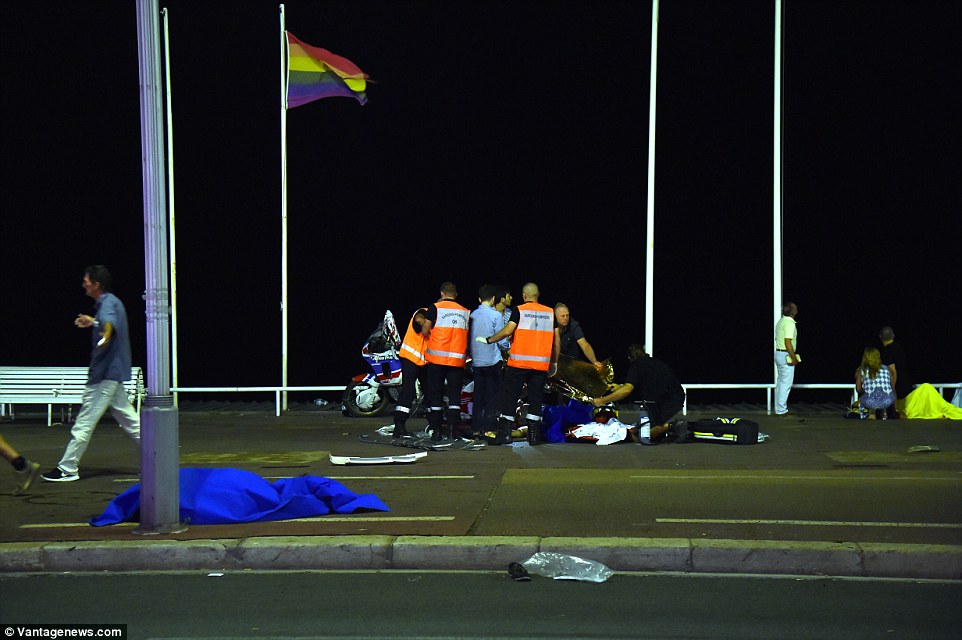 Emergency: Paramedics and doctors try to save a life of an injured victim - surrounded by bodies of those killed yesterday