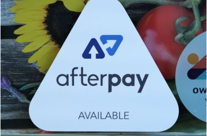 A logo for the company Afterpay is seen in a store window in Sydney, Australia, July 9, 2020. REUTERS/Stephen Coates