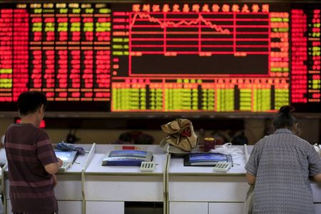 Investors look at computer screens in front of an electronic board showing stock information at a brokerage house in Shanghai, China, September 7, 2015. REUTERS/Aly Song