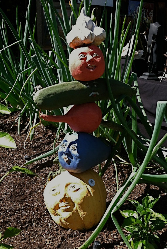Veggie garden totems are made of high fired clay. Each vegetable (tomato, garlic, squash, eggplant, beet, corn, pumpkin, or cauliflower) is handmade and most have a face on either side for viewing from any angle. Designed to welcome friends to your veggie garden, they can also be put in a kitchen for the winter. <3