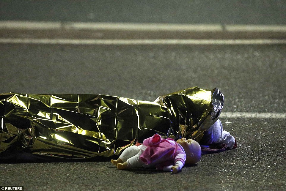 A child&quot;s doll lies on the street beside the body of a young girl who was killed in last night&quot;s attack in Nice in the south of France