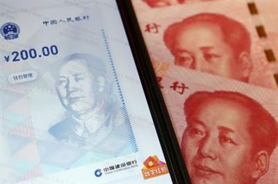 FILE PHOTO: China's official app for digital yuan is seen on a mobile phone next to 100-yuan banknotes in this illustration picture taken October 16, 2020. REUTERS/Florence Lo/Illustration/File Photo