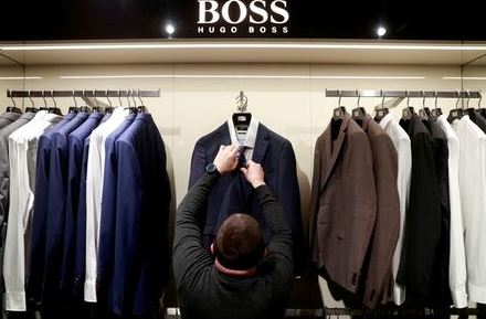 FILE PHOTO: An employee displays suits at the Hugo Boss section of the Central Universal Department Store (TsUM), on the first day after ending a coronavirus lockdown, in Kyiv, Ukraine January 25, 2021. REUTERS/Valentyn Ogirenko/File Photo