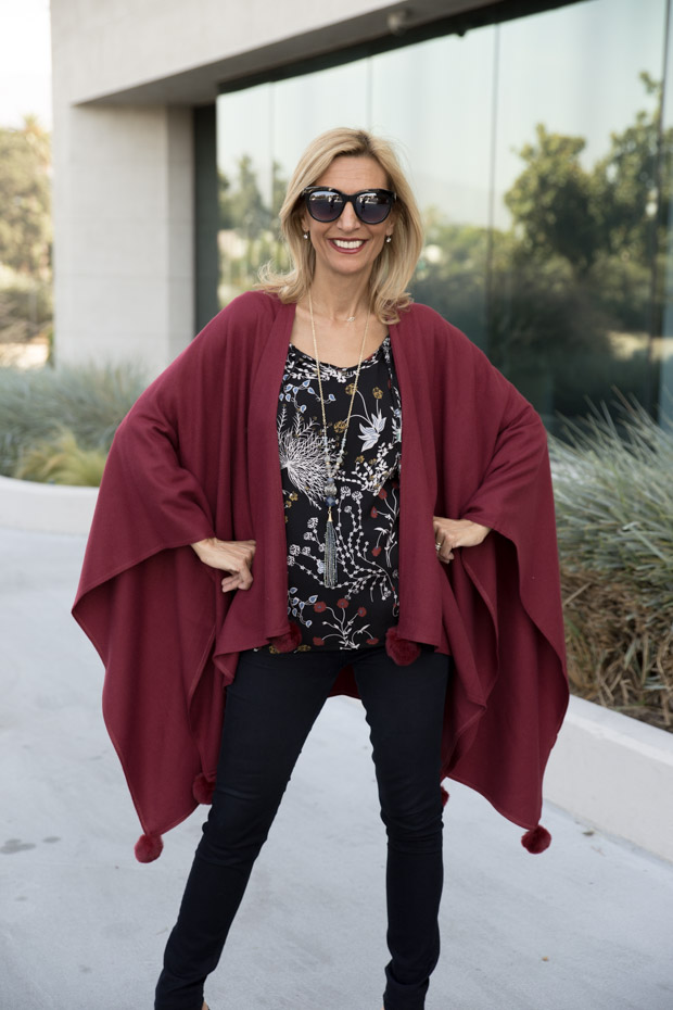 womens burgandy color poncho with fur ball trim