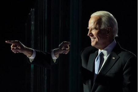 Democratic 2020 U.S. presidential nominee Joe Biden points a finger at his election rally, after news media announced that Biden has won the 2020 U.S. presidential election, in Wilmington, Delaware, U.S., November 7, 2020. REUTERS/Kevin Lamarque