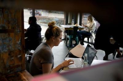 Kathryn Boeker works at a coffee shop as the state of Texas lifts its mask mandate and allows businesses to reopen at full capacity during the coronavirus disease (COVID-19) pandemic in Houston, Texas, U.S., March 10, 2021. REUTERS/Callaghan O'Hare