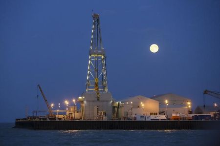 The full moon rises in the background over an oil rig at the Kashagan offshore oil field in the Caspian sea in western Kazakhstan August 21, 2013. After costing nearly $50 billion, mostly paid by some of the world's top oil companies, Kashagan may now be delayed until 2015, jeopardising a forecast budget boost for Kazakhstan of $28 billion - about a third - between 2014 and 2016. Picture taken August 21, 2013. To match Insight KAZAKHSTAN-KASHAGAN/INSIGHT REUTERS/Stringer (KAZAKHSTAN - Tags: ENERGY BUSINESS ENVIRONMENT)