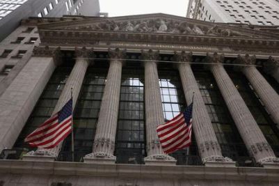 Flags are seen outside the New York Stock Exchange (NYSE) in New York City, where markets roiled after Russia continues to attack Ukraine, in New York, U.S., February 24, 2022. REUTERS/Caitlin Ochs