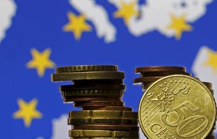 Euro coins are seen in front of displayed flag and map of European Union in this picture illustration taken in Zenica, May 28 2015. The president of the European Central Bank called on euro zone countries to reform their economies, warning that future growth, in the face of entrenched unemployment and low investment, will be modest. REUTERS/Dado Ruvic