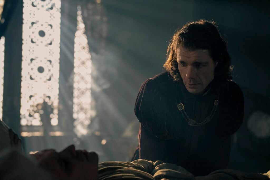 Matthew Needham as Lord Larys Strong tends to Aegon.