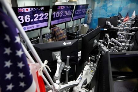 An employee of the foreign exchange trading company works in front of monitors showing the Japanese yen exchange rate against foreign currencies at a dealing room in Tokyo, Japan November 9, 2020. REUTERS/Issei Kato